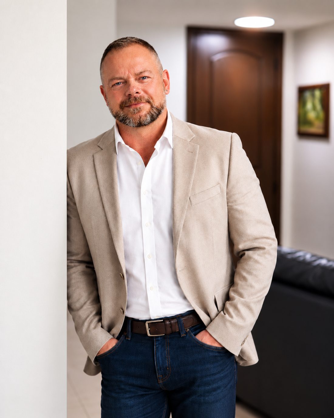 Chuck Kinney, founder of SynquUp, smiling in a light jacket and white shirt