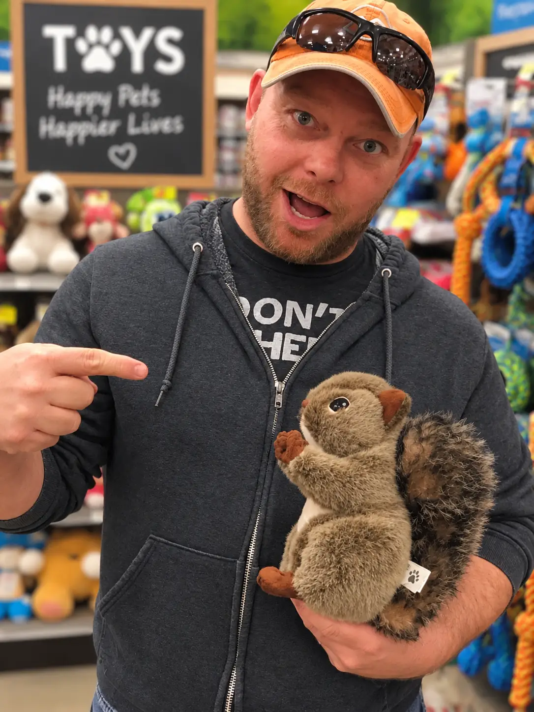 Chuck pointing at a plush squirrel toy in a pet store aisle, a nod to the adult ADHD Squirrel joke