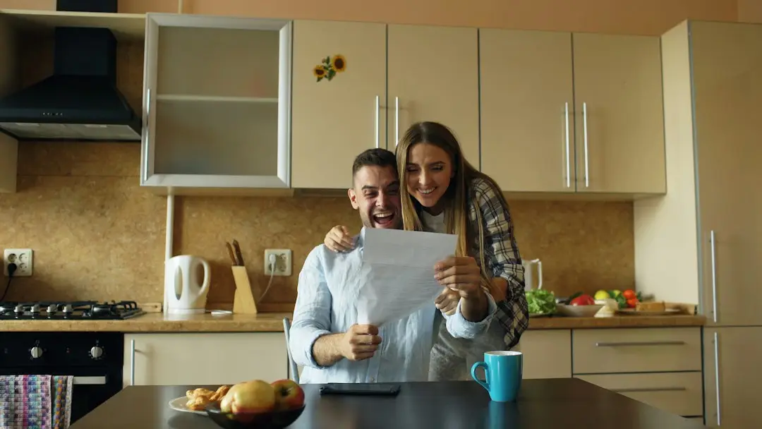 Older couple happily reading a letter together at home, such as an Extra Help approval