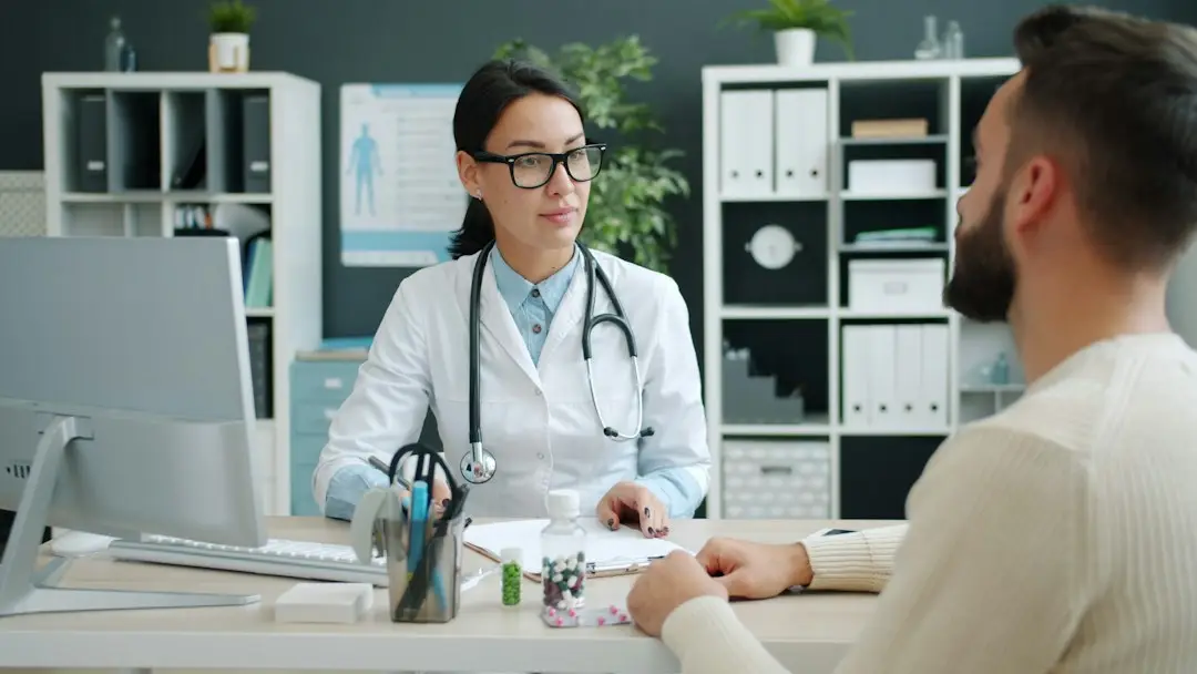 A patient talking with a doctor about a skin condition such as psoriasis
