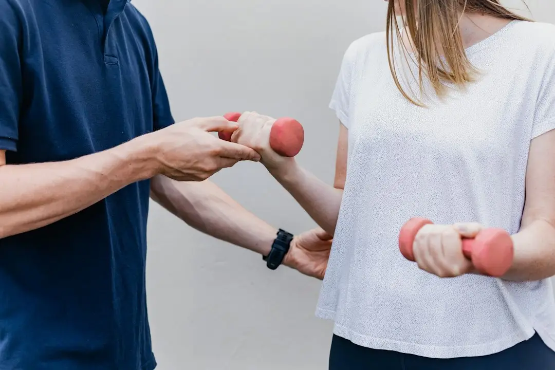 A physical therapist guiding a patient through exercises as part of a chronic pain plan