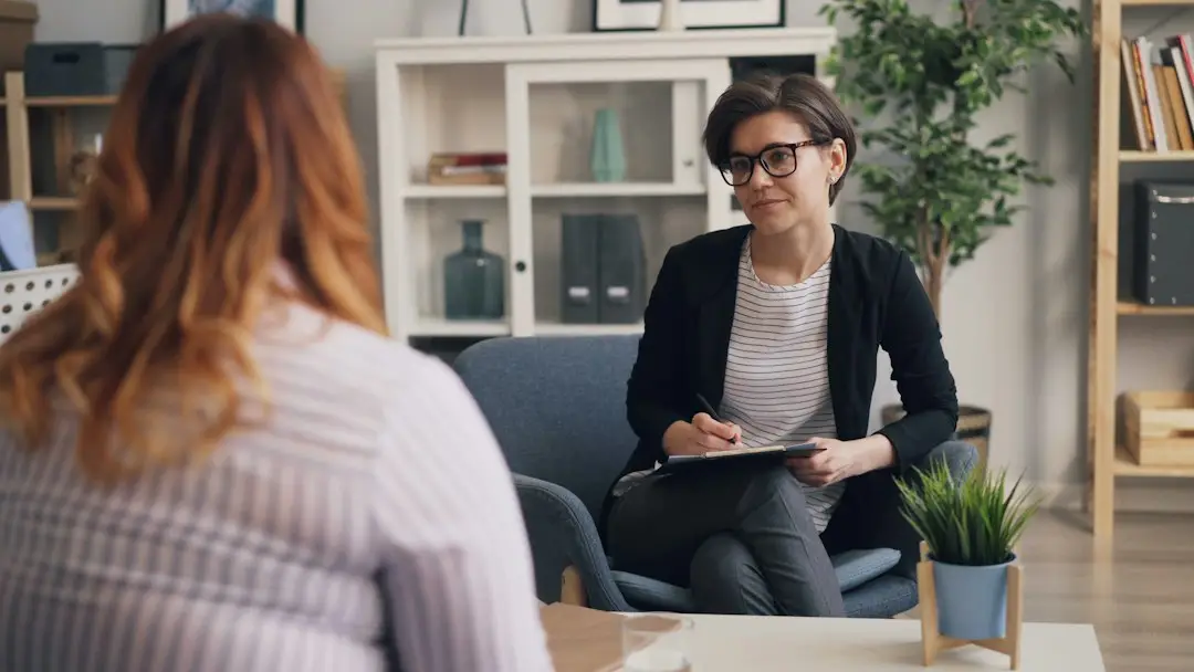 A woman talking with her clinician about possible ovarian cancer symptoms