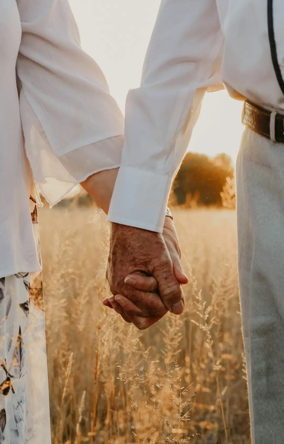An older person holding hands with a loved one, a reminder of why Alzheimer's awareness matters