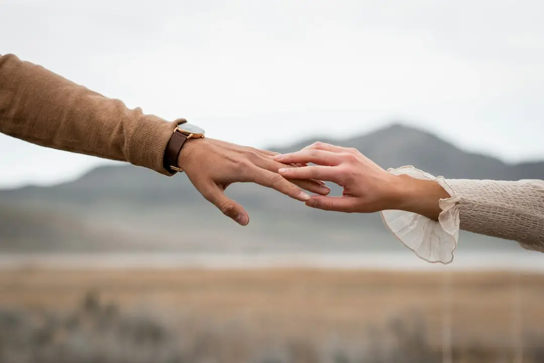 Two hands touching, showing connection and care for sexual health