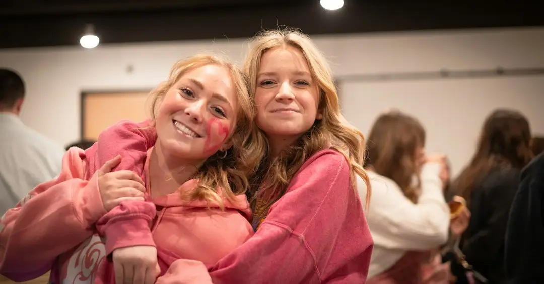 Two women hugging in support of a friend living with metastatic breast cancer